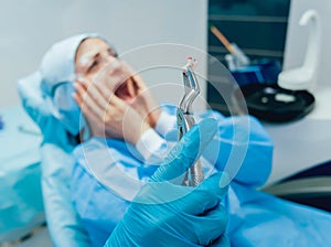 Dentist using surgical pliers to remove a decaying tooth.