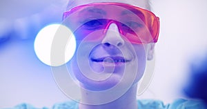 Dentist using UV hardener during surgey at healthcare clinic