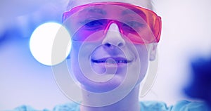 Dentist using UV hardener during surgey at healthcare clinic