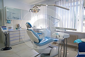 A dentist utilizes modern equipment, like an intraoral scanner or digital X-ray machine.