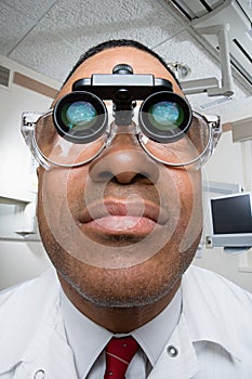 Dentist wearing dental binocular loupes