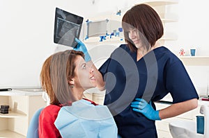 Dentist woman holding x-ray and smiling