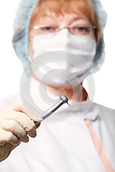 Dentist woman mask holding tools ready to operate