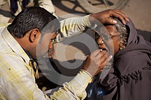 Dentist with a woman patient at the roadside in Va