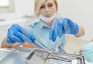 Dentist Woman Picking Mouth Mirror and Probe