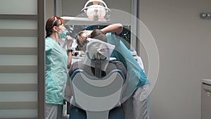 Dentist at work in dental clinic. Steadicam.