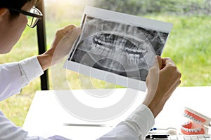 dentist work on the table with Denture and teeth x-ray