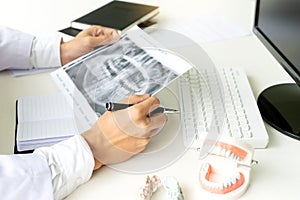 dentist work on the table with Denture and teeth x-ray