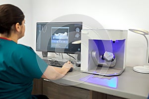 Dentist working on computer with a dental scan software for make dental prosthesis