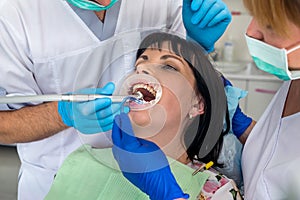 Dentist working with patient in chair, dentistry