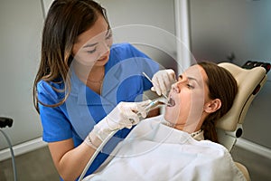 Dentist working with patient in dental chair