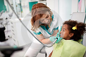 Dentist on working place in dental practice with patient