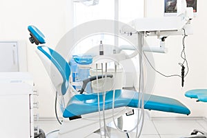 Dentist workspace with modern chair, equipment and instruments