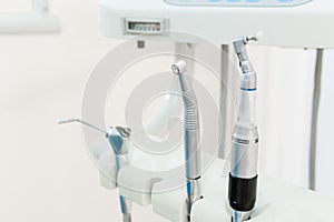 Dentist workspace with modern chair, equipment and instruments