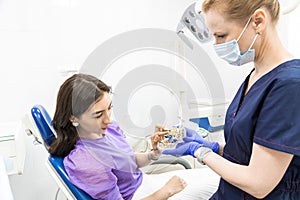 Dentistry concept. Professional dental services and modern equipment without pain. The doctor consults and treats the