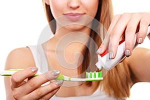 Woman applying toothpaste on her toothbrush