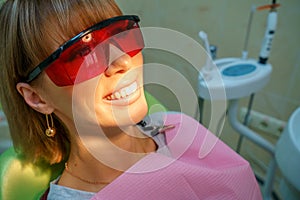 Dentistry happy patient in the chair in goggles