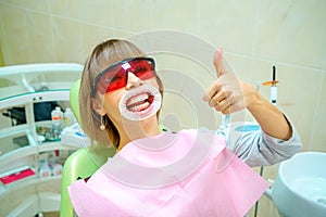 Dentistry happy patient in the chair in goggles