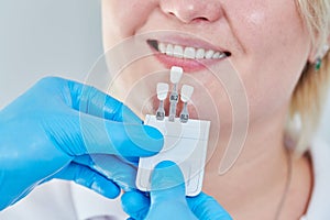 Dentistry. matching colour of the tooth enamel with whitening chart photo