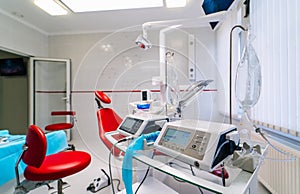 dentistry, medicine, medical equipment and stomatology concept - interior of new modern dental clinic office with chair