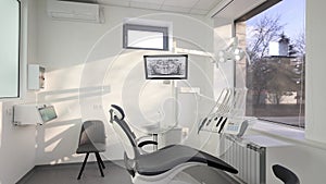 Dentistry office with professional modern equipment. Empty minimalistic stomatology office with dental unit, chair and