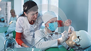 Dentistry student or hygienist working on a dummy photo