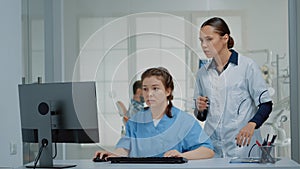 Dentistry team of specialists looking at computer screen