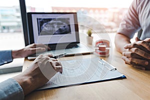 Dentists are discussing dental problems at report x-ray image on laptop screen to patients