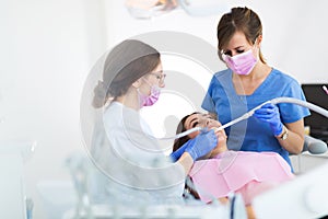 Dentists and patient in dentist office