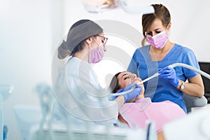 Dentists and patient in dentist office