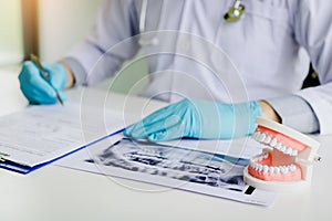 Dentists are taking note of patient details in the office room