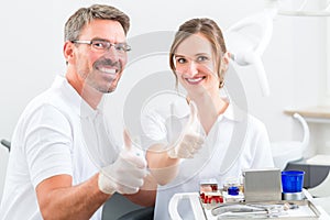 Dentists in their surgery or office with dental tools photo