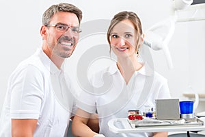 Dentists in their surgery or office with dental tools photo