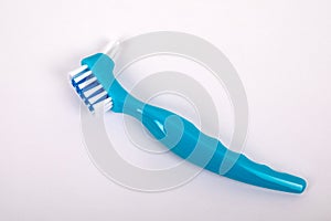 Denture toothbrush on a white background. Effective cleaning of teeth and gums