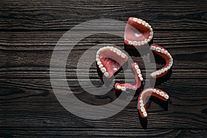 Dentures on a dark background. Close-up of dentures. Full removable plastic denture of the jaws. Prosthetic dentistry.