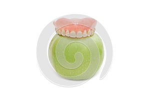 Dentures with green apple photo