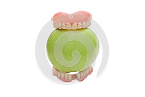 Dentures with green apple, isolated