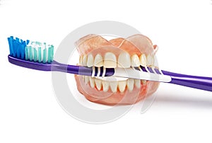 Dentures with toothbrush