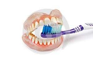 Dentures with toothbrush