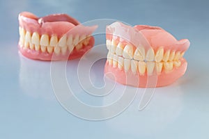 The dentures of the two elderly people were placed on a shiny white table