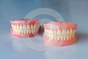 The dentures of the two elderly people were placed on a shiny white table