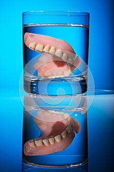 Dentures in a water glass photo