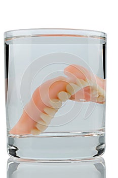 Dentures in water glass photo