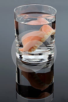 Dentures in water glass photo