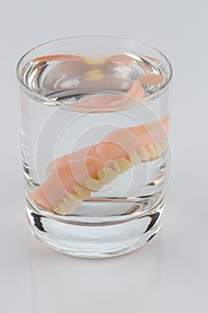 Dentures in a water glass photo
