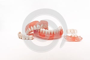 Dentures on a white background. Close-up of dentures. Full removable plastic denture of the jaws. Prosthetic dentistry.