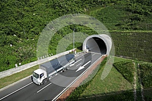 A truck passing tunnel under a mountain. photo