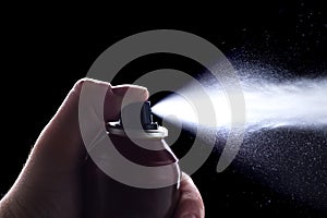 Deodorant in hand isolated on black