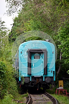 The departing train, the last blue car of the outgoing train from the railway