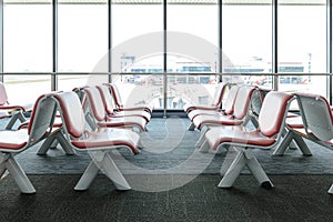 Departure lounge with empty chairs in the terminal of airport